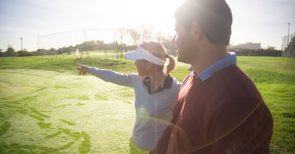 a man and woman communicating on a golf course discussing strategy and enjoying the sunny day outdo